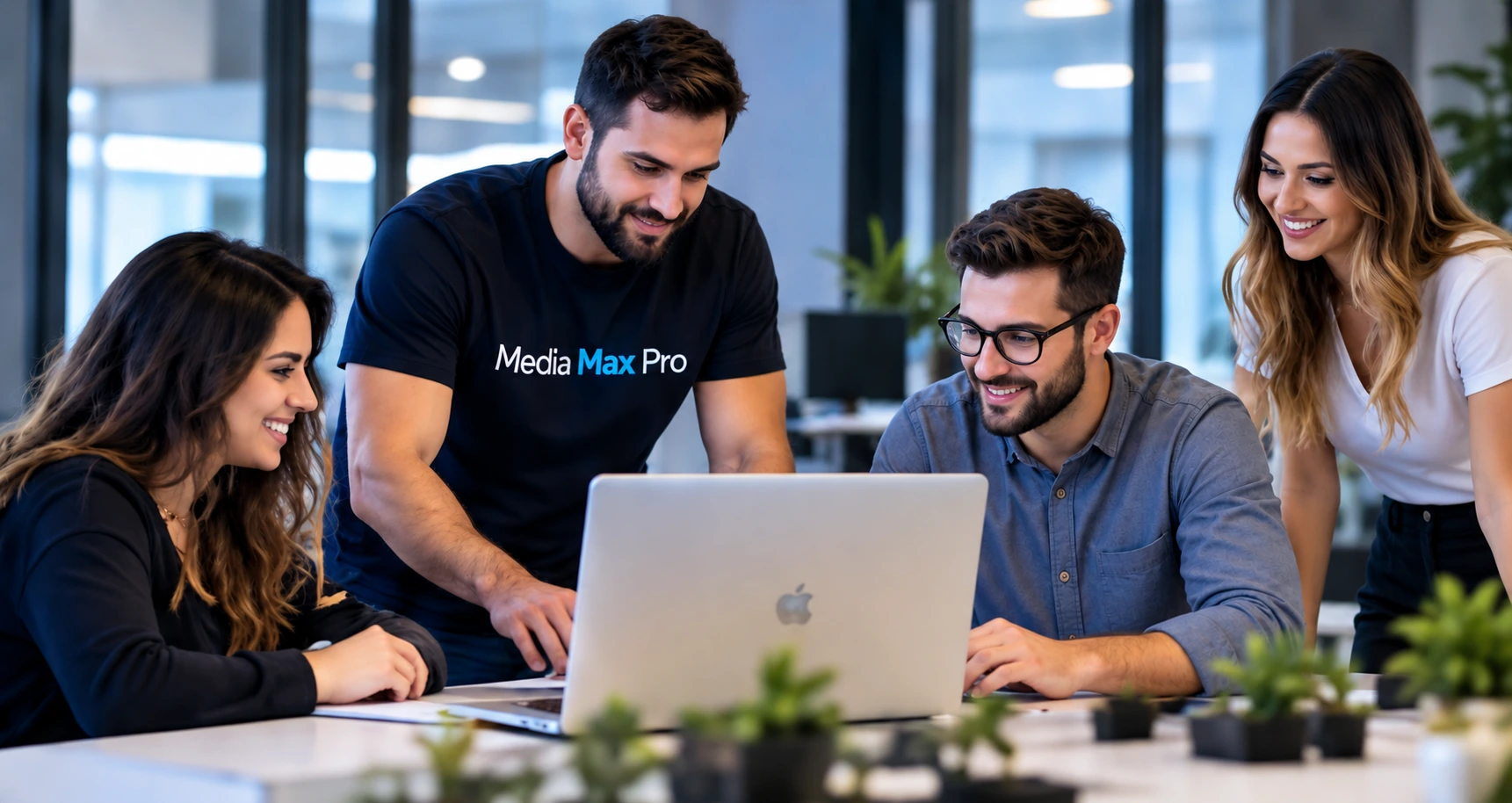 A collaborative team working together around a laptop.